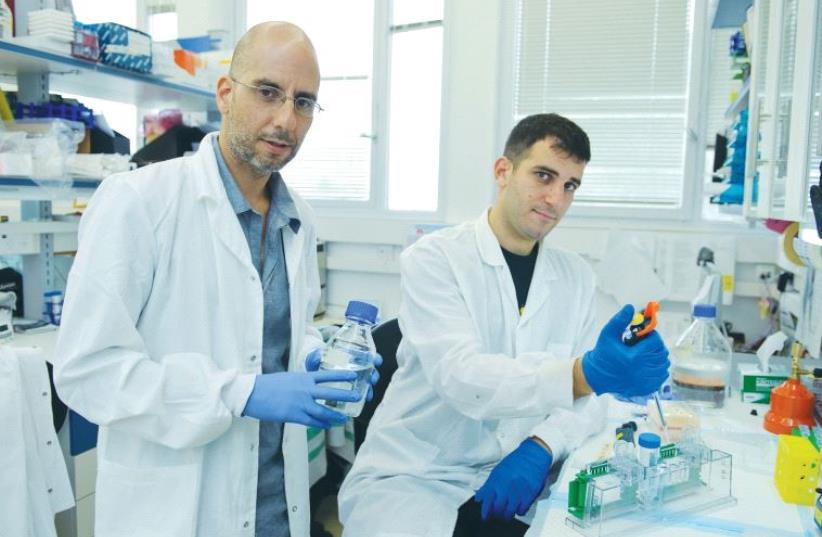 DR. GAD ASHER (left) stands alongside a colleague at the Weizmann Institute of Science in Rehovot. (photo credit: WEIZMANN INSTITUTE OF SCIENCE)