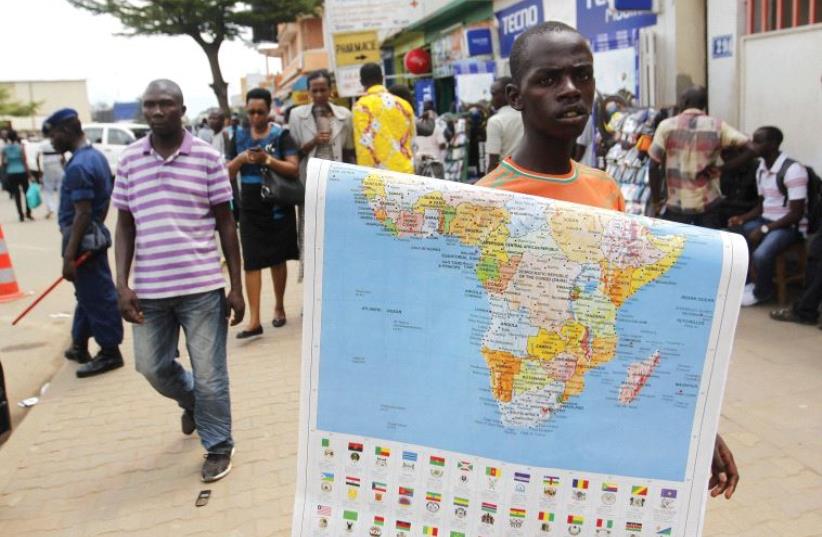 NEW FRIENDS everywhere for Israel. A vendor sells a map of Africa along the streets of Bujumbura, Burundi, last year. (photo credit: REUTERS)