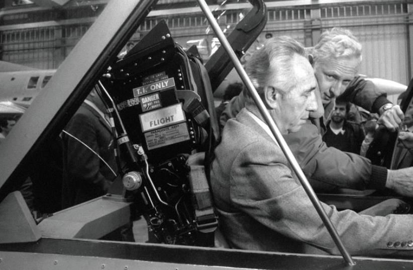 Peres sits in the cockpit of a mock-up Lavi jet fighter in 1985 (photo credit: GPO)