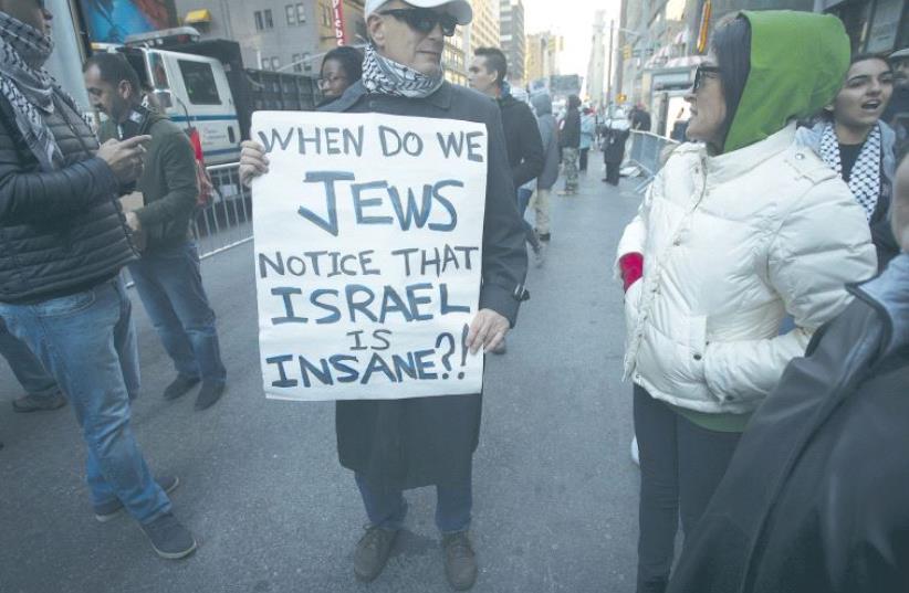 A DEMONSTRATOR holds a sign during a pro-Palestinian protest in Times Square, New York, last year. (photo credit: REUTERS)