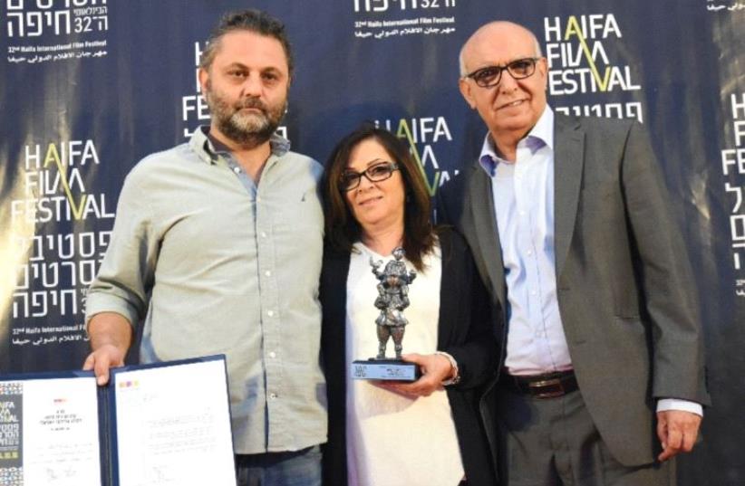 ACTORS MAHMOUD SHAWAHDEH (right) and Sana Shawahdeh pose with producer Baher Agbariya (left) after winning Best Feature Israeli Film for ‘Personal Affairs’ at the Haifa Film Festival. (photo credit: GALIT ROSEN)