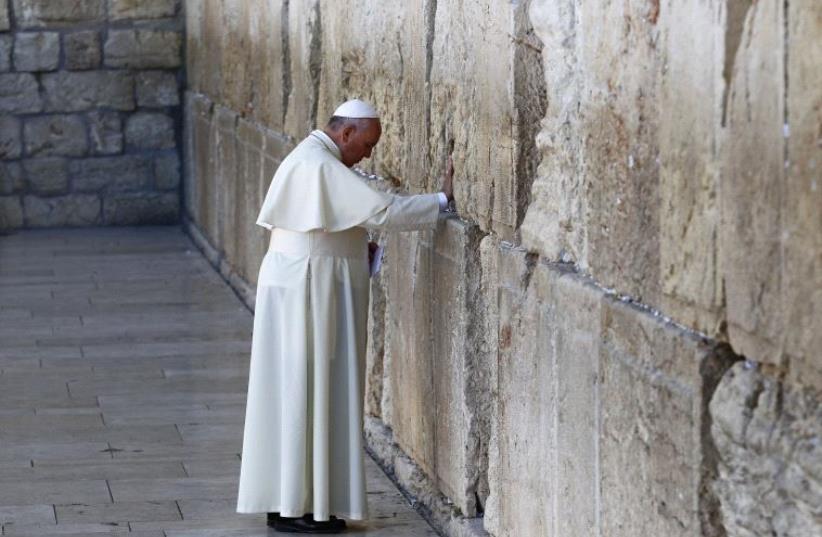 Pope Francis at the Western Wall in the Old City of Jerusalem during his May 2014 visit to Israel (photo credit: REUTERS)