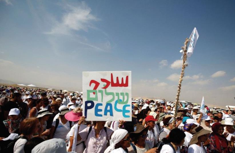 Activists, including Israelis and Palestinians, take part in a demonstration in support of peace near Jericho (photo credit: REUTERS)