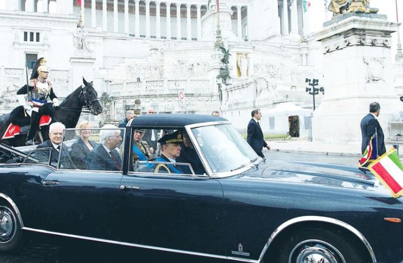 ITALIAN PRESIDENT Sergio Mattarella is escorted by presidential guards as they pass in front of Vittoriano’s monument during the Republic Day military parade in Rome in June. (photo credit: REUTERS)