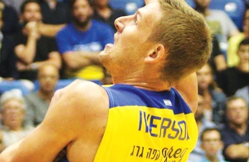 Maccabi Tel Aviv center Colton Iverson aims to build on his recent improved form when the yellow-and-blue visits Hapoel Tel Aviv tonight in BSL action. (photo credit: ADI AVISHAI)