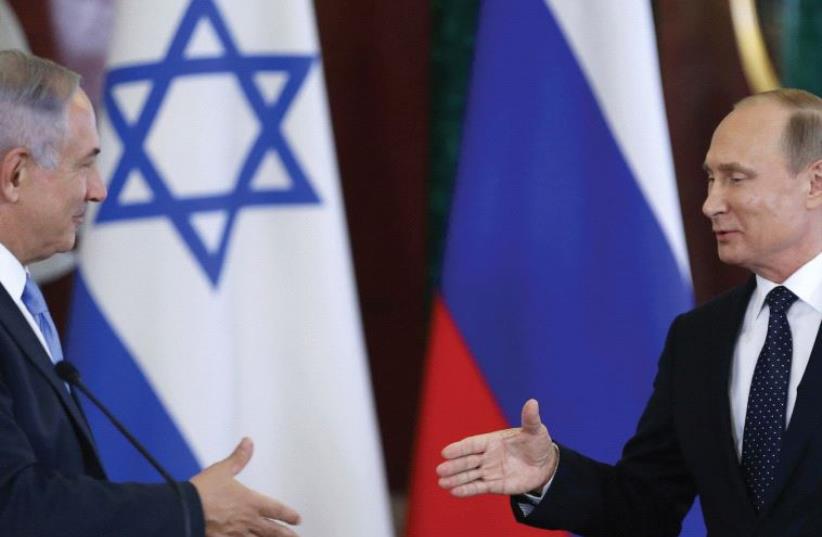 RUSSIAN PRESIDENT Vladimir Putin shakes hands with Prime Minister Benjamin Netanyahu during a news conference at the Kremlin in Moscow (photo credit: REUTERS)