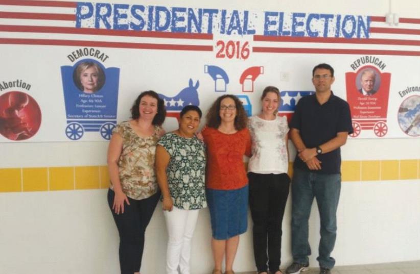 At the Ironi Heh High School, the English teachers who taught the election project flank some of the visuals (photo credit: Courtesy)