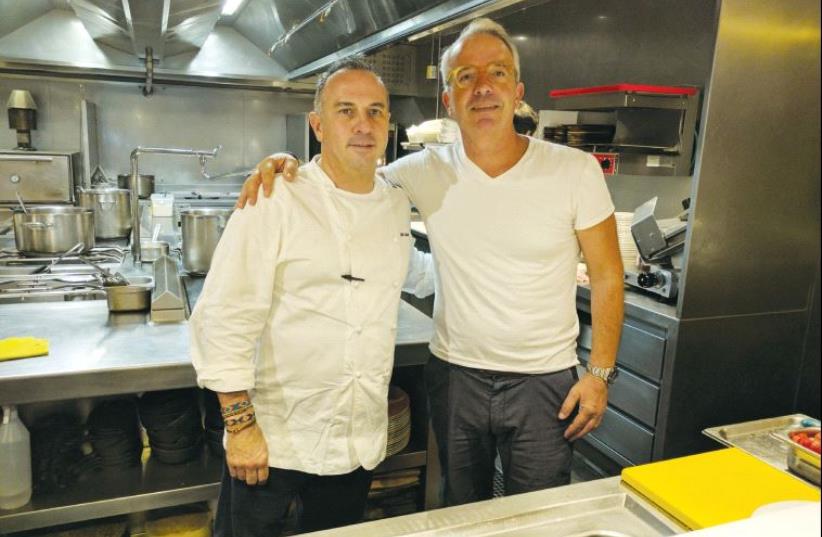 The writer (right), with Chef Miki Calzad in his restaurant in Barcelona (photo credit: AYA MASSIAS)