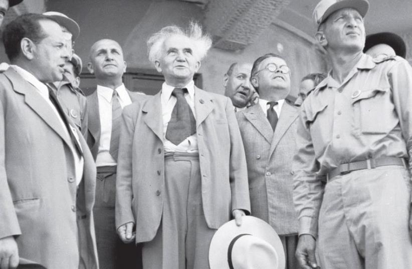 Then-Prime Minister David Ben- Gurion (center) watches the plane coming in carrying Theodor Herzl’s coffin at Lod airport, on August 16, 1949 (photo credit: DIAMOND SAM/GPO)