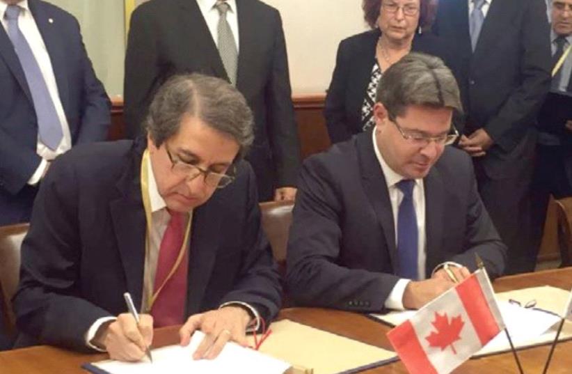 SCIENCE, TECHNOLOGY and Space Minister Ofir Akunis (right) and Dr. Alejandro Adem sign the Canadian-Israeli cooperation agreement (photo credit: SCIENCE MINISTRY)