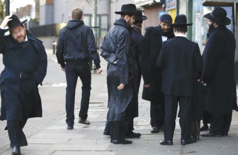 JEWISH MEN share a conversation in Golders Green, London, in January 2015. (photo credit: REUTERS)