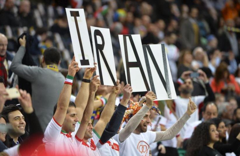 Iran's fans cheer for their team (photo credit: REUTERS/HENRIK MONTGOMERY/TT NEWS AGENCY)