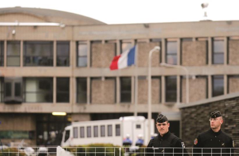 Des policiers en faction devant un bâtiment (photo credit: REUTERS)