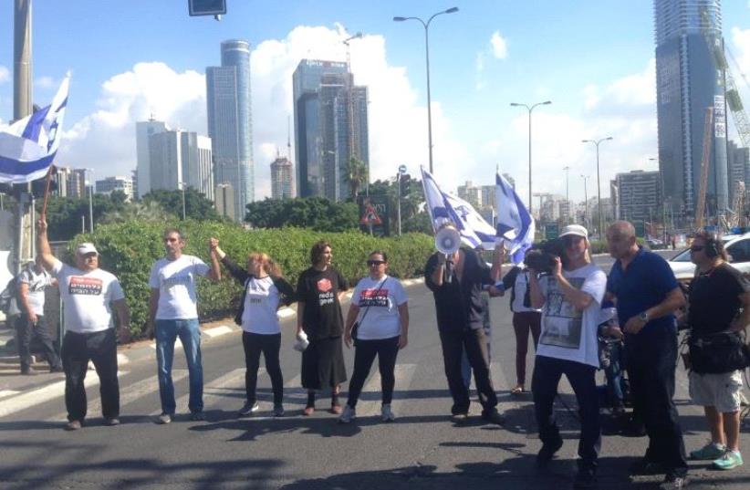 Vicki Knafo (third from left) leads a march of handicapped and financially disadvantaged persons in Tel Aviv on Sunday.  (photo credit: ELIYAHU KAMISHER)