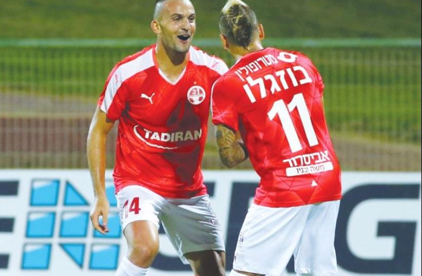 Hapoel Beersheba striker Ben Sahar (left) celebrates with teammate Maor Buzaglo after scoring his second goal in last night’s 5-1 win at Hapoel Ashkelon. (photo credit: UDI ZITIAT)