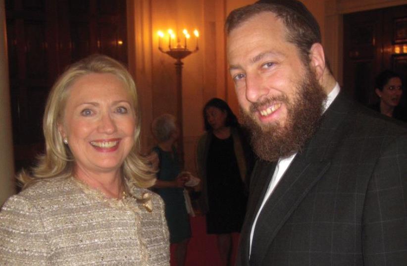 EZRA FRIEDLANDER, CEO of the public affairs consulting firm The Friedlander Group, seen here with Hillary Clinton a few years ago. Friedlander says the hassidic vote is much more complex than some of the candidates realize. (photo credit: Courtesy)