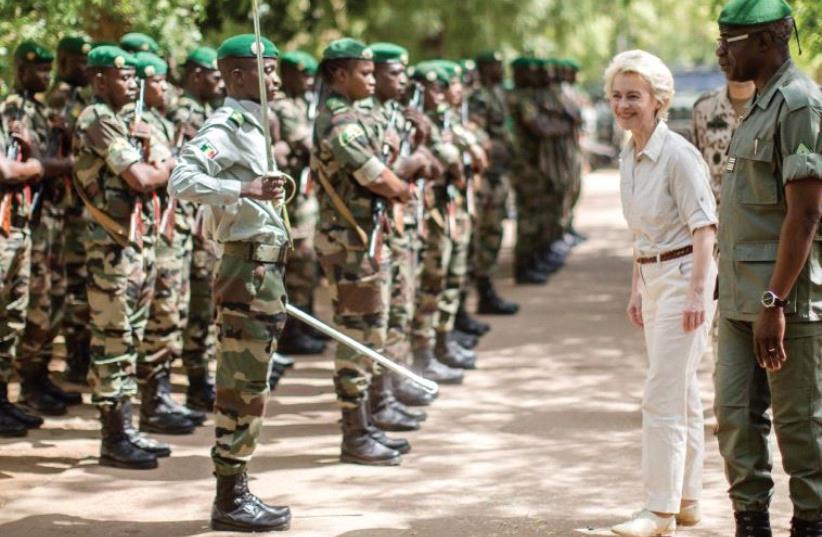 GERMAN DEFENSE MINISTER Ursula von der Leyen is received with a guard of honor of Malian soldiers as she visits the EU training mission in Koulikoro, Mali, in April. (photo credit: REUTERS)