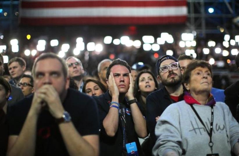 Supporters of Hillary Clinton watch and wait at her election night rally in New York. Supporters of Hillary Clinton watch and wait at her election night rally in New York.  (photo credit: REUTERS)