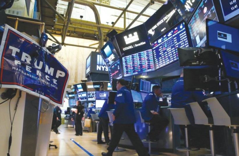 A TRUMP poster is displayed on the floor of the New York Stock Exchange (photo credit: REUTERS)