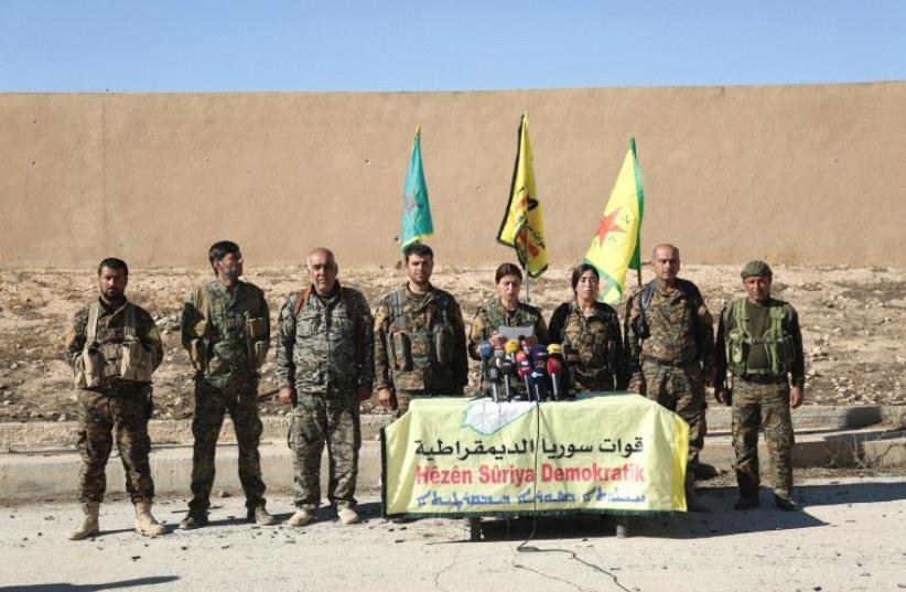 SYRIAN DEMOCRATIC FORCES commanders announce an offensive to take the ISIS-held city of Raqqa last week. (photo credit: RODI SAID / REUTERS)