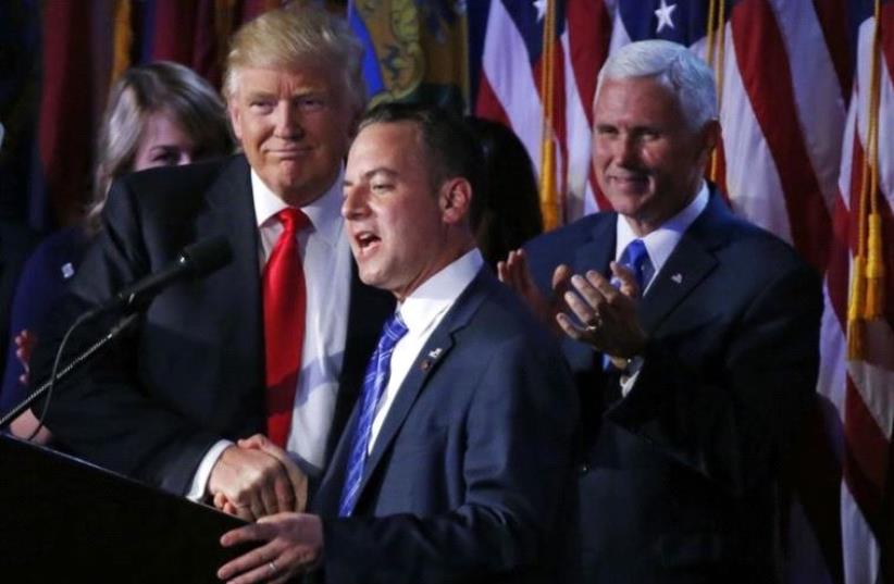 US President elect Donald Trump shakes hands with Republican National Committee Chairman Reince Priebus (C) as Vice President-elect Mike Pence (R) looks onat election night rally in Manhattan, New York, US, November 9, 2016 (photo credit: REUTERS)