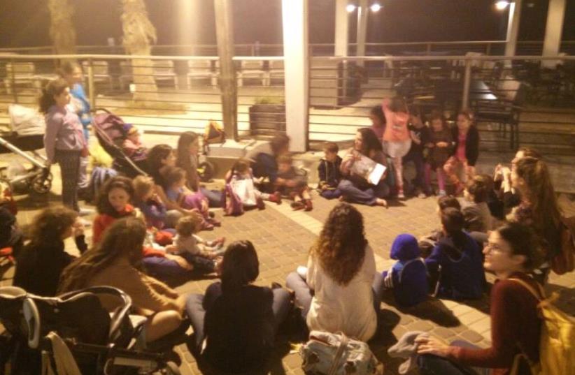 Kids from the Haifa Hand-in-Hand Arab-Jewish kindergarten hold a bilingual story hour in front of a Haifa restaurant, which told workers they cannot speak Arabic around Jewish customers (photo credit: RAJA ZAATRY)