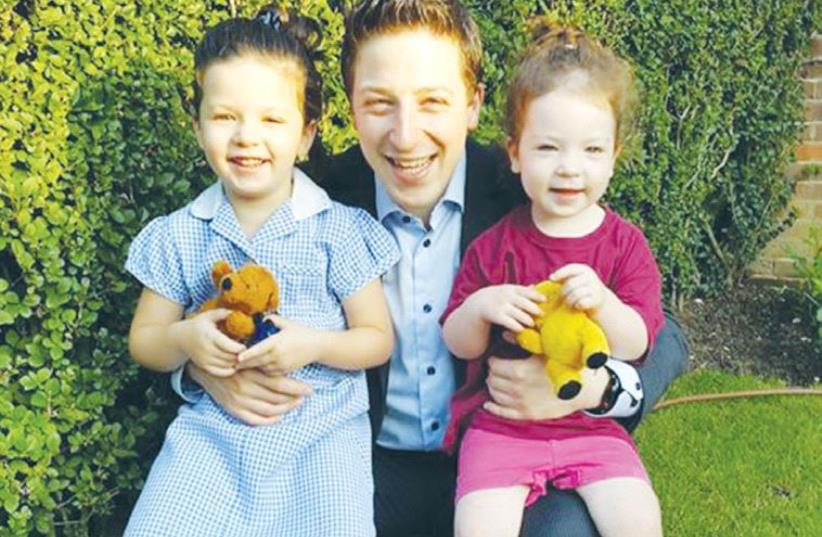 Adam Gordon of London holds his daughters Ariella (left) and Tamara (photo credit: Courtesy)