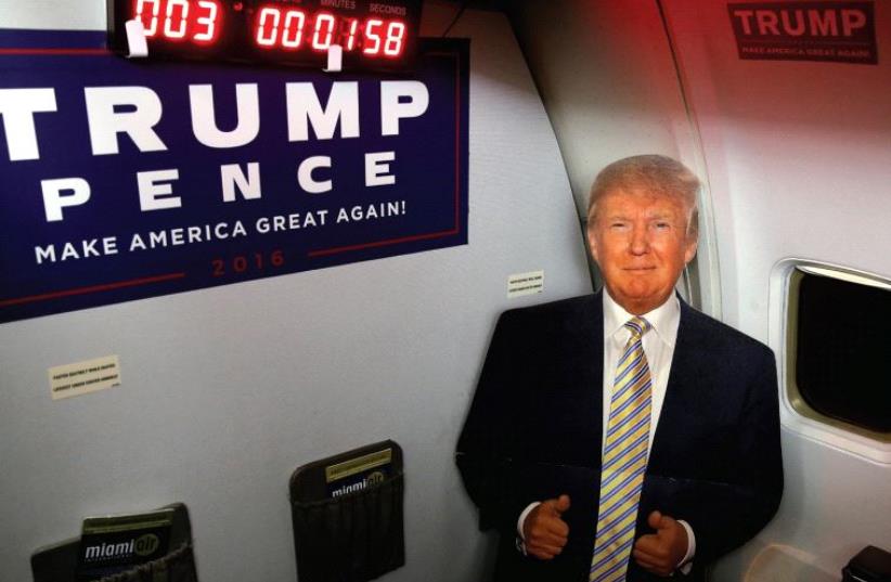 A CARDBOARD cutout of Donald Trump is pictured on a media charter plane with a countdown clock to the election earlier this month. (photo credit: REUTERS)
