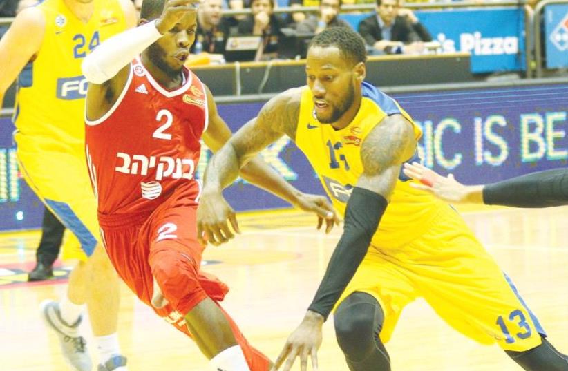 Maccabi Tel Aviv forward Sonny Weems (right) had 10 points in last night’s 85-83 win over Hapoel Jerusalem and Jerome Dyson at Yad Eliyahu Arena. (photo credit: ADI AVISHAI)