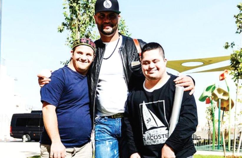 MAJOR LEAGUE BASEBALL superstar Albert Pujols (center), of the Los Angeles Angels, visited Shalva’s new Jerusalem headquarters this week as part of his first trip to Israel. (photo credit: OMER BURIN)
