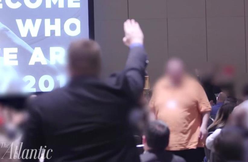 A supporter of the alt-Right giving a Nazi salute. (photo credit: YOUTUBE SCREENSHOT/THE ATLANTIC)