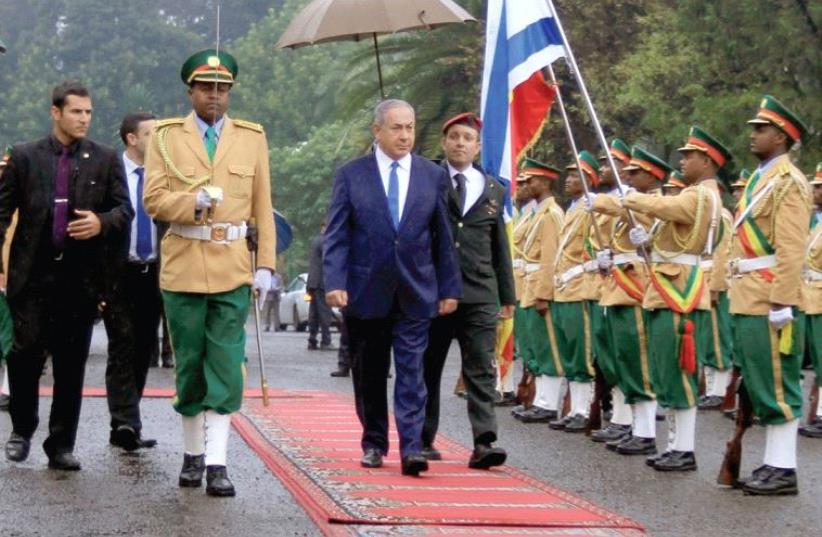 Netanyahu inspects a guard of honor at the National Palace during his State visit to Addis Ababa, Ethiopia, in July (photo credit: REUTERS)