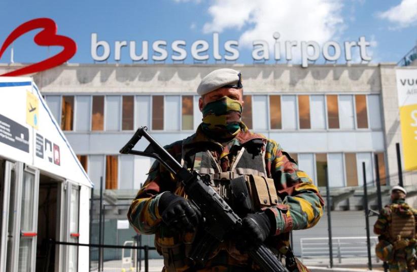 A Belgian soldier stands guard outside the partially reopened departure hall of Zaventem international airport near Brussels, Belgium, May 3, 2016 (photo credit: REUTERS)