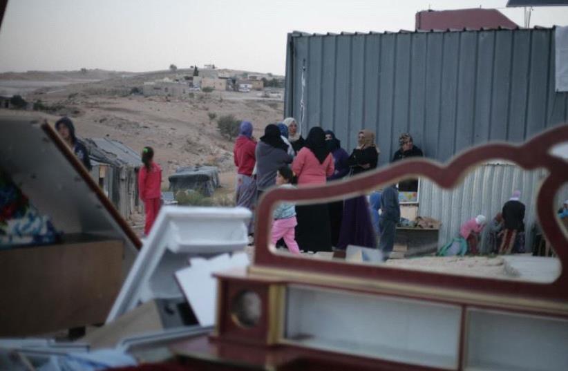 Family gathered around their house which was slated for demolition on Tuesday (photo credit: ELIYAHU KAMISHER)