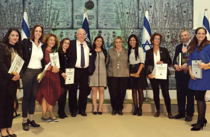 PRESIDENT REUVEN RIVLIN his wife, Nechama, flank Social Equality Minister Gila Gamliel yesterday at an event marking the International Day for the Elimination of Violence Against Women. (photo credit: HAIM ZACH/GPO)