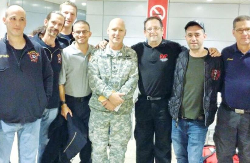 FIRE-FIGHTERS FROM the US smile at Ben-Gurion Airport (photo credit: EITAN CHARNOFF)