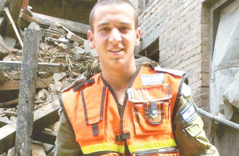 YOAV SASSON stands in front of rubble from a April 2015 earthquake in Nepal where he served as part of the IDF Home Front aid team. (photo credit: Courtesy)