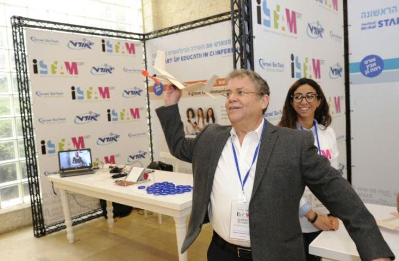 Zvi Peleg, director general of ORT Israel playing with ORT Ramat Gan's projects during the summit.  (photo credit: JORGE NOVOMINSKI)