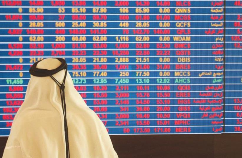 A TRADER monitors stock information at the Qatar Stock Exchange in Doha (photo credit: REUTERS)