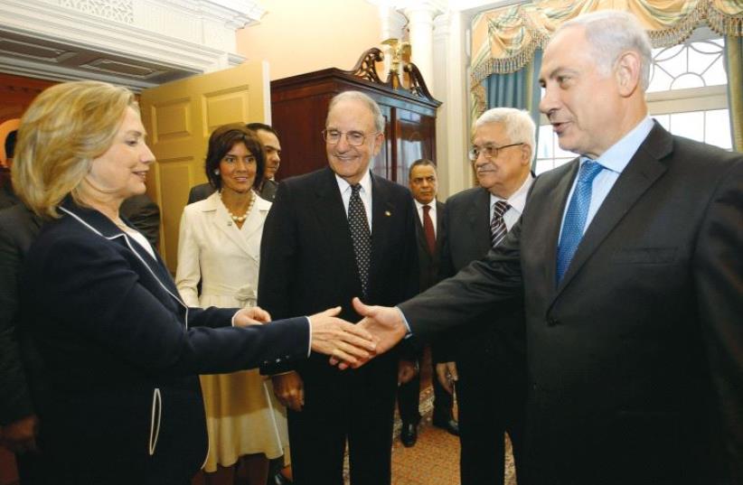 Then-US secretary of state Hillary Clinton welcomes Prime Minister Benjamin Netanyahu, PA President Mahmoud Abbas and US Special Envoy for Middle East Peace George Mitchell to the State Department in Washington in September 2010 (photo credit: REUTERS)