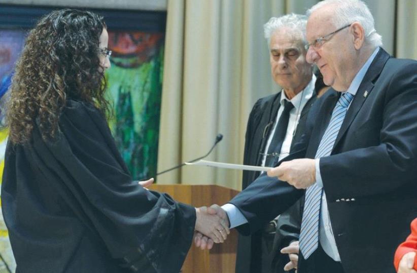 PRESIDENT REUVEN RIVLIN speaks with Jerusalem Magistrate’s Court Judge Miriam Banki yesterday, as National Labor Court President Yigal Plitman looks on. (photo credit: MARK NEYMAN/GPO)