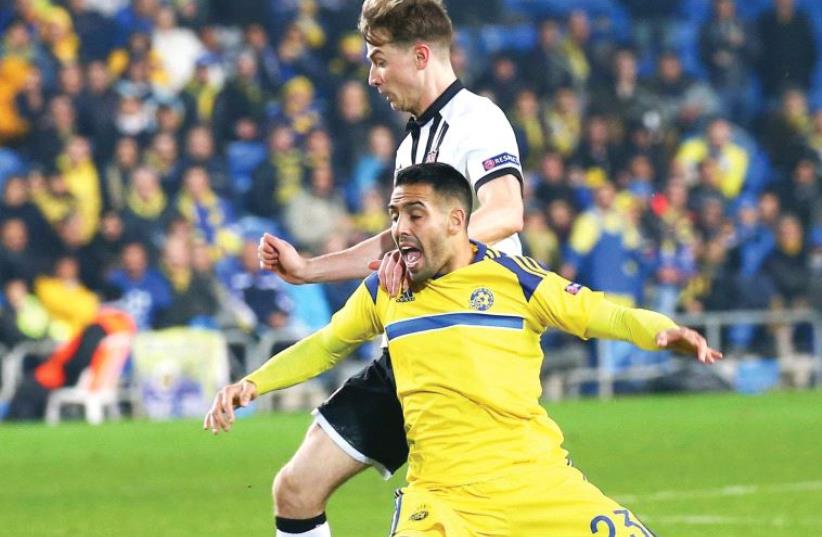 Maccabi Tel Aviv was pushed out of Europe last night despite a 2-1 win over Dundalk, with midfielder Eyal Golasa being muscled off the ball by Dundalk’s Seán Gannon. (photo credit: DANNY MARON)