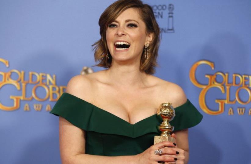 Rachel Bloom poses with her award for Best Performance by an Actress in a Television Series - Musical or Comedy for her role in "Crazy Ex-Girlfriend" backstage at the 73rd Golden Globe Awards in Beverly Hills, California January 10, 2016 (photo credit: REUTERS)
