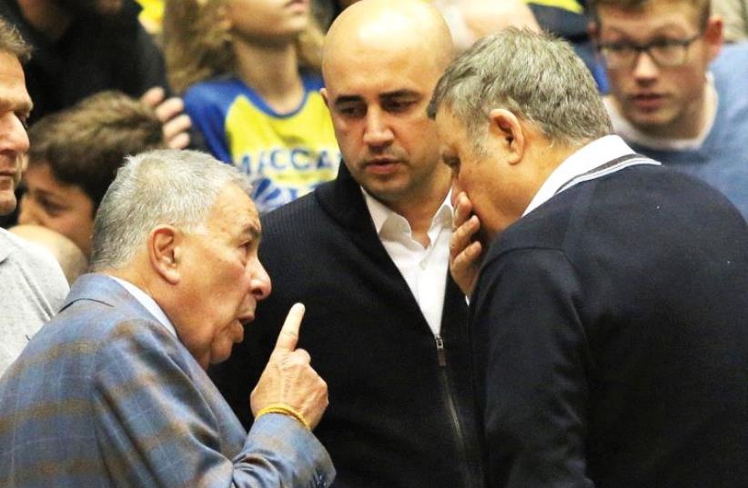 Maccabi Tel Aviv owners Shimon Mizrahi (left) and David Federman (right) and club CEO Hagay Badash (center) are not short of talking points these days, including what the future holds for the BSL. (photo credit: ADI AVISHAI)