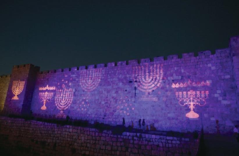 Hanukkiot projected on the walls of Jerusalem’s Old City during Hanukka last year (photo credit: MARC ISRAEL SELLEM/THE JERUSALEM POST)