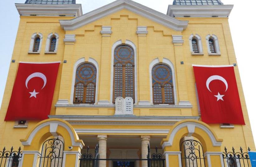 TURKISH FLAGS hang on the facade of the restored Great Synagogue before a re-opening ceremony in Edirne, in 2015. (photo credit: REUTERS)