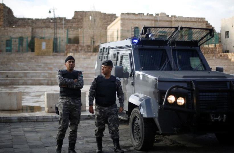 Jordanian policemen stand guard after ending the security operations in the vicinity of Karak Castle, where armed gunmen carried out an attack yesterday, in the city of Karak, Jordan, December 19, 2016 (photo credit: REUTERS)