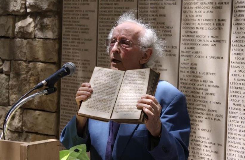 Dr. Lucien Lazare, member of the Jewish resistance in France and member of the Commission for the Designation of the Righteous, shows the Bible he received from Pastor Ducommun after liberation, Yad Vashem, 27 April 2010 (photo credit: YAD VASHEM)