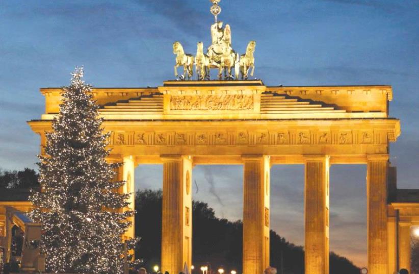 An illuminated Christmas tree is pictured in front of the Brandenburg Gate in Berlin, last month (photo credit: REUTERS)
