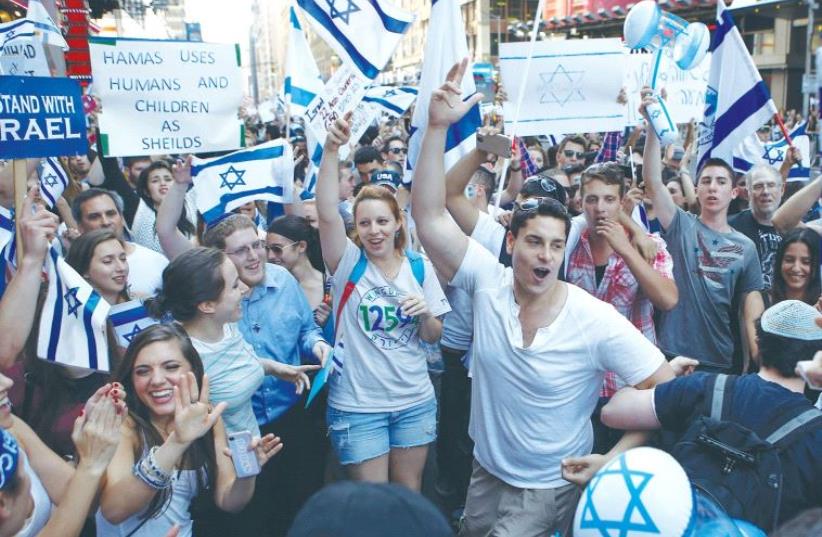 PRO-ISRAEL SUPPORTERS dance during a rally in New York’s Times Square in 2014. (photo credit: REUTERS)